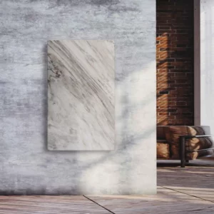 Natursteinheizung Palisandro als eleganter Wandakzent in einem Loft mit Sichtbeton und Ziegelwand – Luxuswärme