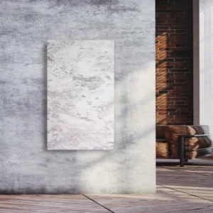 Natursteinheizung Varios als eleganter Wandakzent in einem Loft mit Sichtbeton und Ziegelwand – Luxuswärme